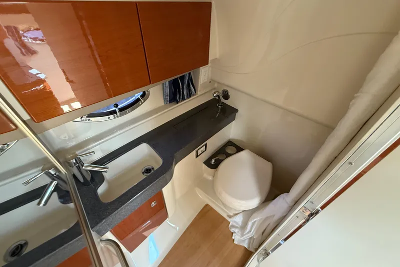 Slide: The Image of 2012 Formula 350 Sun Sport bathroom with sink, toilet, and wooden cabinetry. - 42