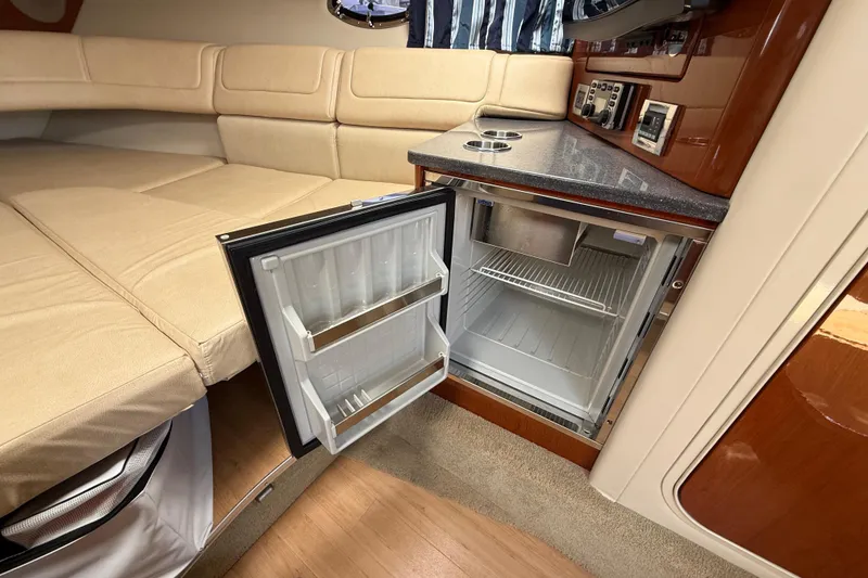 Slide: The Image of Interior of 2012 Formula 350 Sun Sport with open mini fridge and beige seating. - 44