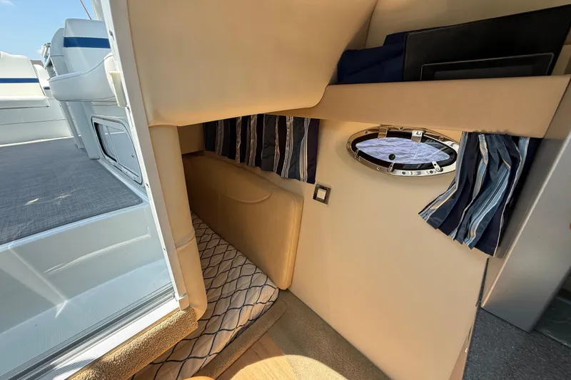 Slide: The Image of Interior cabin of 2012 Formula 350 Sun Sport boat with porthole and striped curtains. - 45