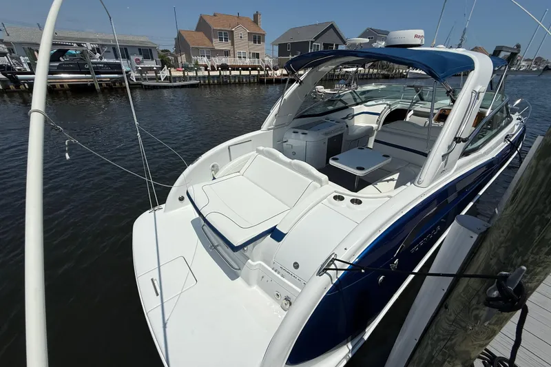 Slide: The Image of 2012 Formula 350 Sun Sport boat docked, featuring sleek design and spacious seating. - 5