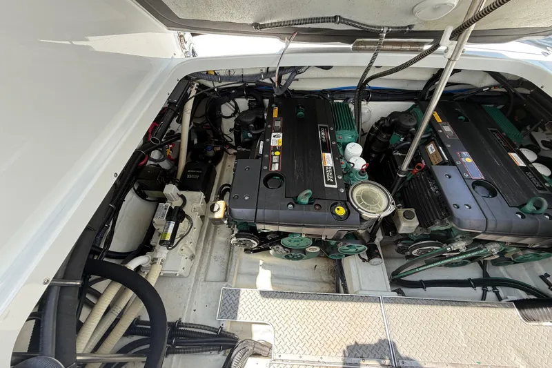 Slide: The Image of Engine compartment of a 2012 Formula 350 Sun Sport boat, showcasing dual engines and components. - 52