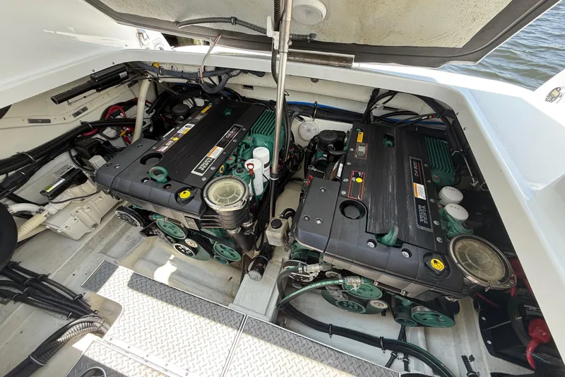 Slide: The Image of Engine compartment of a 2012 Formula 350 Sun Sport boat, showcasing dual engines. - 54