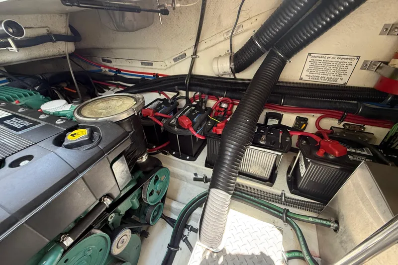 Slide: The Image of Engine compartment of a 2012 Formula 350 Sun Sport boat, showcasing batteries and wiring. - 56