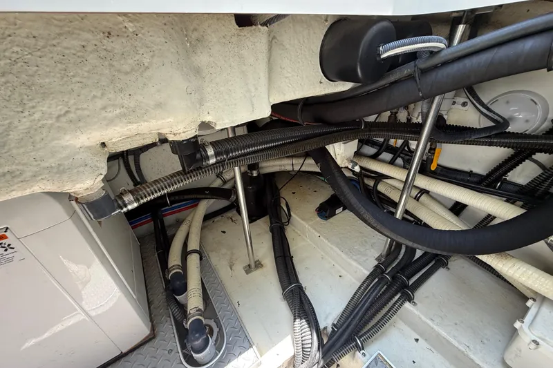Slide: The Image of Engine compartment of a 2012 Formula 350 Sun Sport boat, showcasing hoses and wiring. - 58