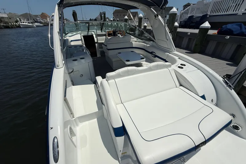 Slide: The Image of 2012 Formula 350 Sun Sport boat with spacious white seating and sleek design at a dock. - 8