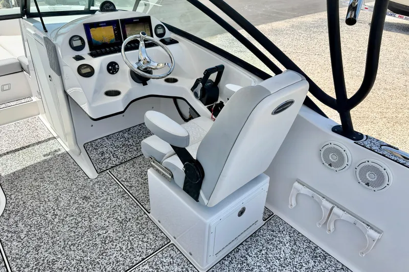 Slide: The Image of 2021 Twin Vee 240 GFX DC boat cockpit with modern controls and seating. - 12