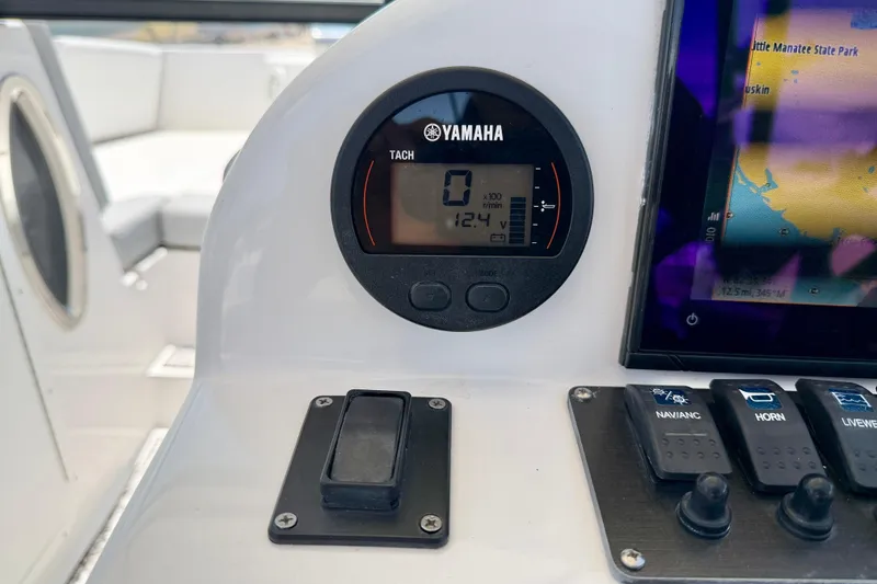 Slide: The Image of Yamaha tachometer and navigation controls on 2021 Twin Vee 240 GFX DC boat dashboard. - 16