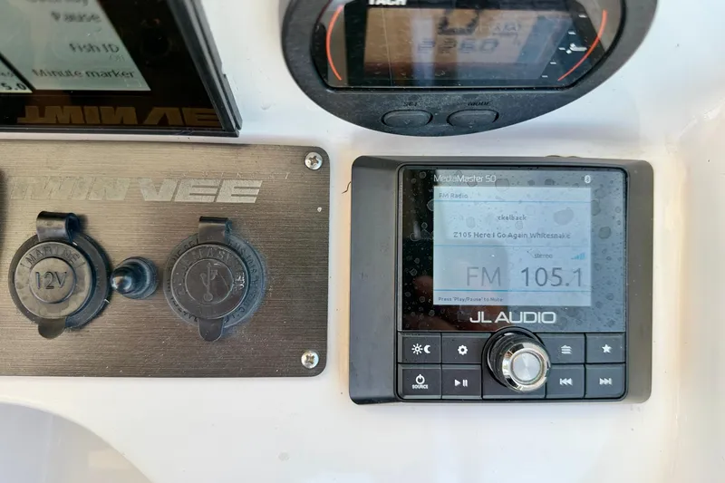Slide: The Image of Dashboard of a 2021 Twin Vee 240 GFX DC with JL Audio system and 12V outlets. - 18