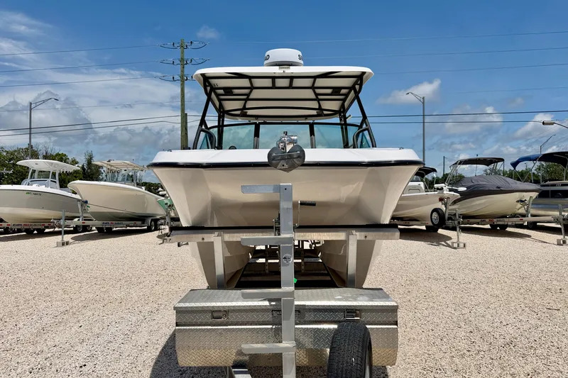 Slide: The Image of 2021 Twin Vee 240 GFX DC boat on trailer, displayed outdoors under blue sky. - 2