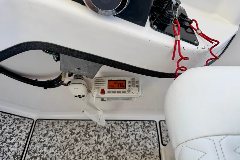 Slide: The Image of Control panel of 2021 Twin Vee 240 GFX DC boat with radio and safety lanyards. - 21