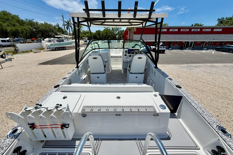 Slide: The Image of 2021 Twin Vee 240 GFX DC boat interior with seating and fishing equipment. - 25