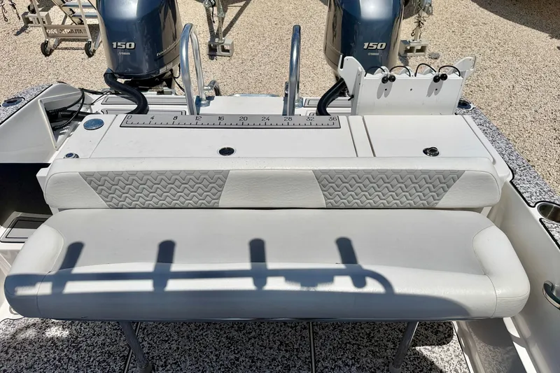 Slide: The Image of 2021 Twin Vee 240 GFX DC boat with dual Yamaha 150 engines and cushioned seating. - 26