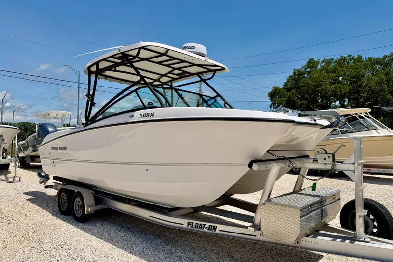 Slide: The Image of 2021 Twin Vee 240 GFX DC boat on trailer, displayed outdoors under clear sky. - 3