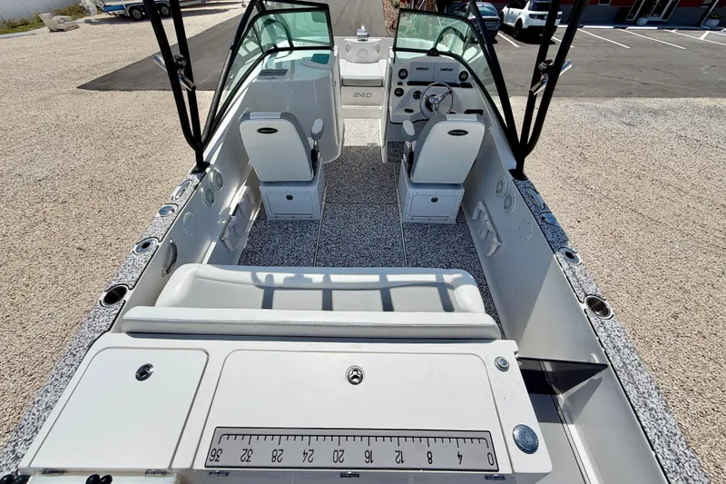 Slide: The Image of 2021 Twin Vee 240 GFX DC boat interior with seating and dashboard view. - 32