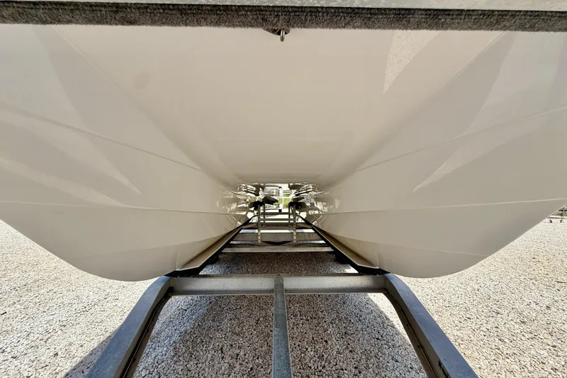 Slide: The Image of Underneath view of 2021 Twin Vee 240 GFX DC catamaran hull on trailer. - 33