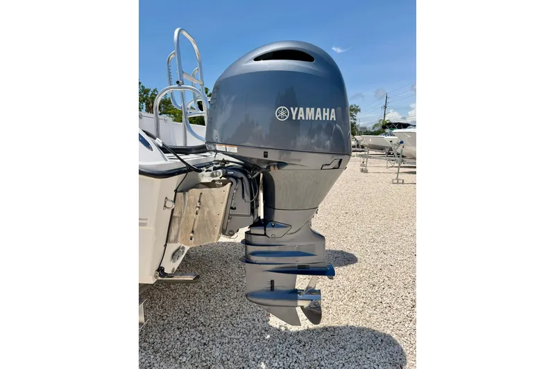 Slide: The Image of Yamaha outboard motor on 2021 Twin Vee 240 GFX DC boat, parked on gravel. - 34