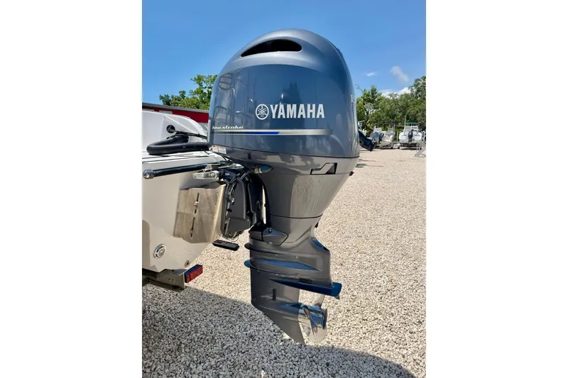 Slide: The Image of Yamaha outboard motor on 2021 Twin Vee 240 GFX DC boat, parked on gravel. - 35