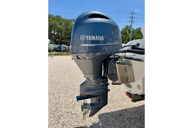 Slide: The Image of Yamaha outboard motor on 2021 Twin Vee 240 GFX DC boat, parked on gravel. - 36