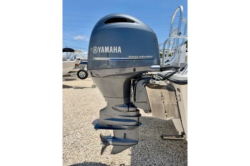 Slide: The Image of Yamaha four-stroke outboard motor on 2021 Twin Vee 240 GFX DC boat, parked on gravel. - 37