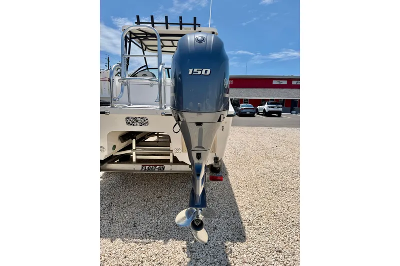 Slide: The Image of 2021 Twin Vee 240 GFX DC boat with 150 HP outboard motor on gravel. - 39