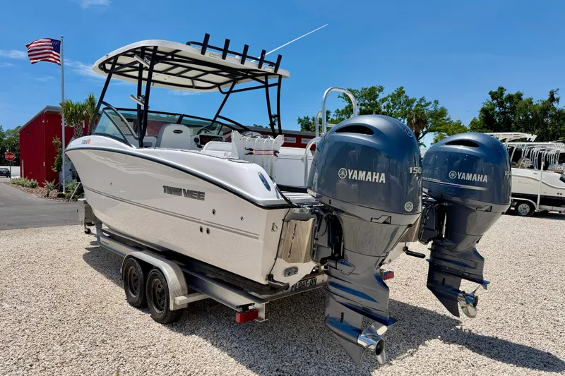 Slide: The Image of 2021 Twin Vee 240 GFX DC boat with dual Yamaha 150 engines on a trailer. - 7