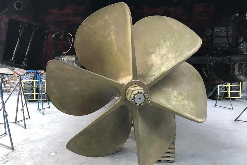Slide: The Image of Large propeller of a 2011 Baia ONE HUNDRED yacht in a maintenance area. - 74