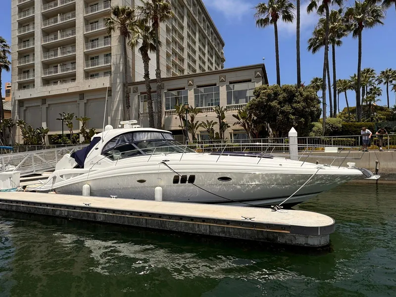 Slide: The Image of 2008 Sea Ray Sundancer yacht docked near a waterfront hotel with palm trees. - 3