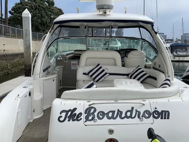 Slide: The Image of 2008 Sea Ray Sundancer yacht named "The Boardroom" with striped cushions, docked at a marina. - 40