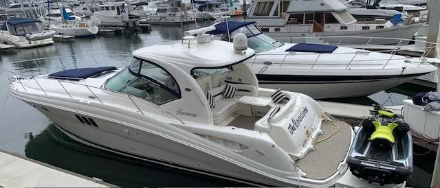 Slide: The Image of 2008 Sea Ray Sundancer yacht docked at marina with jet ski nearby. - 44