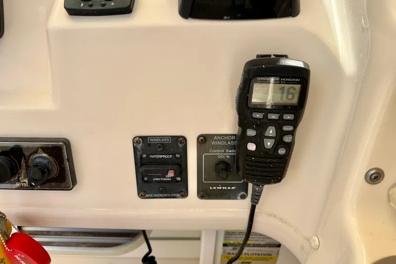 Slide: The Image of Control panel of a 2016 Grady-White Journey 258 boat with radio and windlass switches. - 11