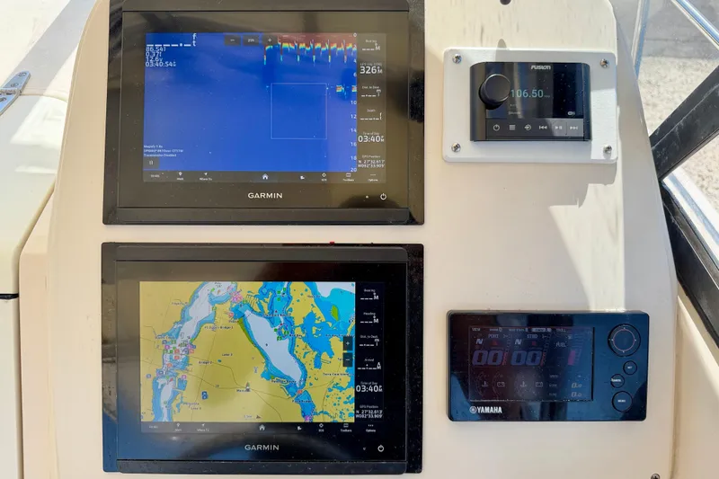 Slide: The Image of Dashboard of a 2016 Grady-White Journey 258 with Garmin navigation displays. - 12