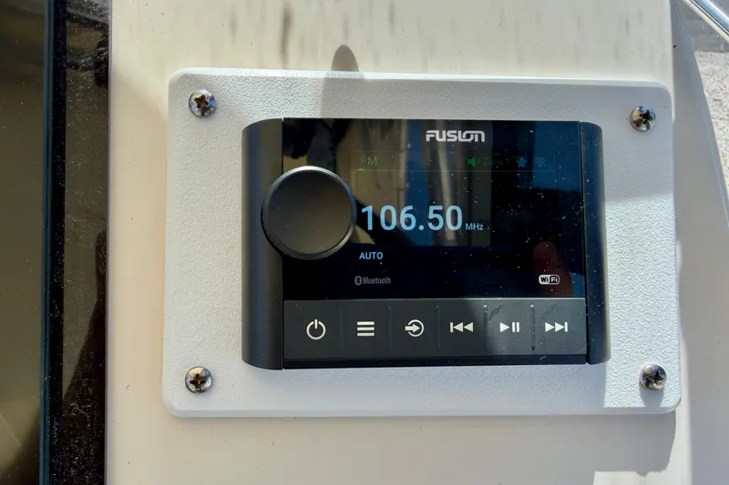 Slide: The Image of Fusion marine stereo display on a 2016 Grady-White Journey 258 boat, showing 106.50 MHz. - 14