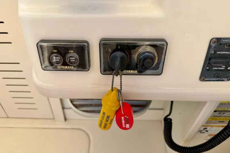 Slide: The Image of Control panel of a 2016 Grady-White Journey 258 boat with Yamaha ignition keys. - 16