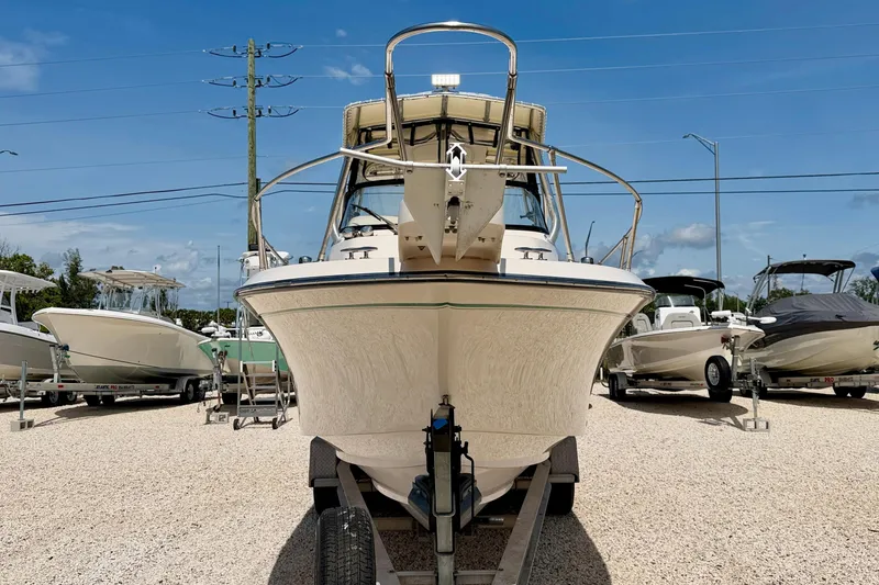 Slide: The Image of 2016 Grady-White Journey 258 boat on trailer, displayed outdoors under clear blue sky. - 2