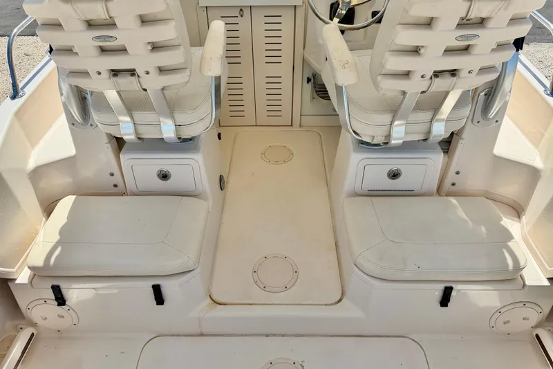 Slide: The Image of 2016 Grady-White Journey 258 boat interior with seating and storage compartments. - 20