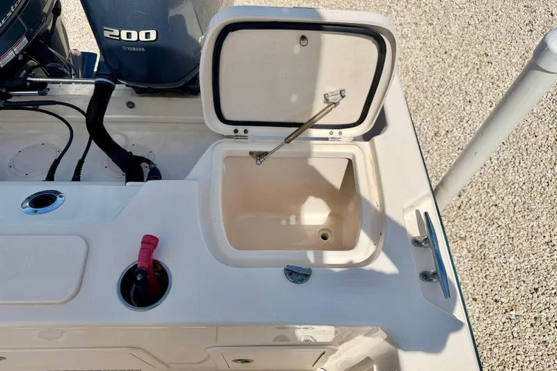 Slide: The Image of Open storage compartment on 2016 Grady-White Journey 258 boat deck, near Yamaha 200 engine. - 21