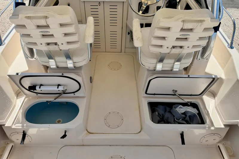 Slide: The Image of 2016 Grady-White Journey 258 boat interior with storage compartments and seating. - 22