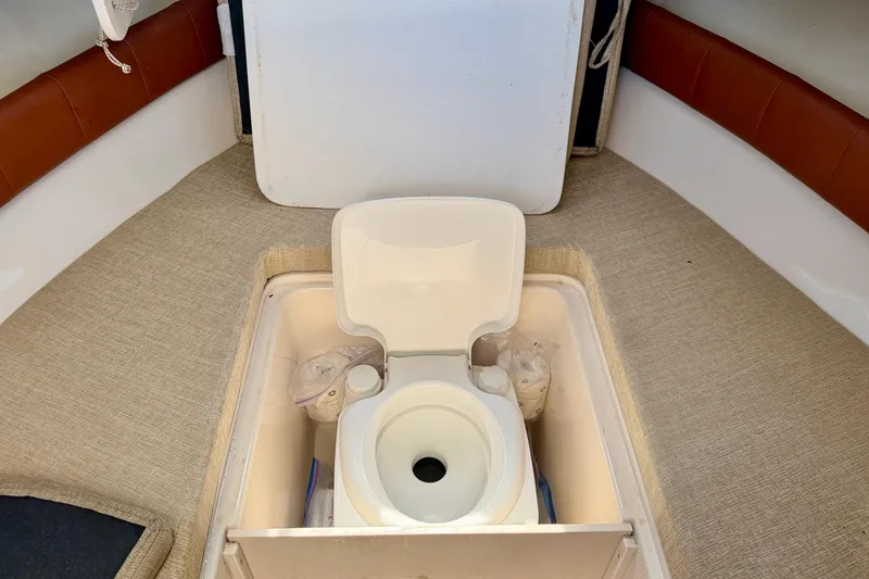 Slide: The Image of 2016 Grady-White Journey 258 boat interior with built-in toilet. - 25