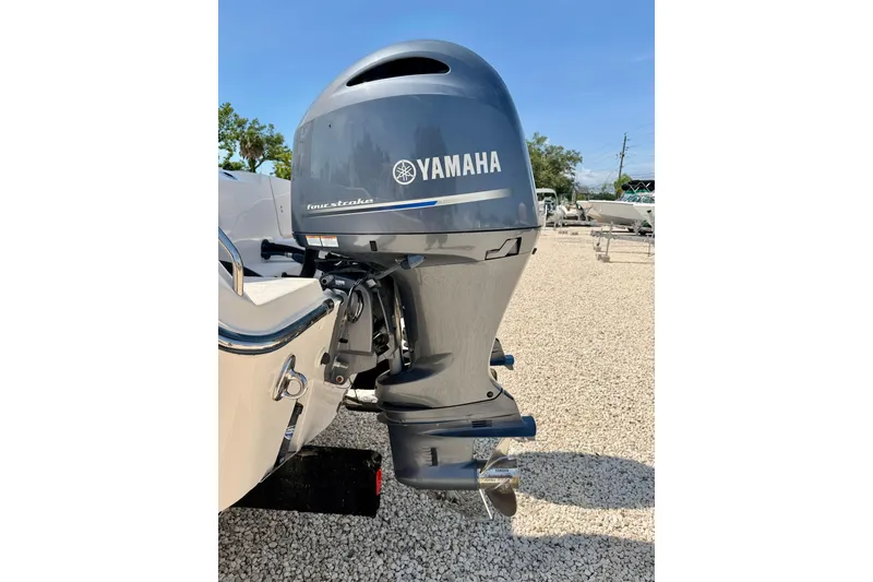 Slide: The Image of 2016 Grady-White Journey 258 with Yamaha four-stroke outboard motor, parked on gravel. - 28