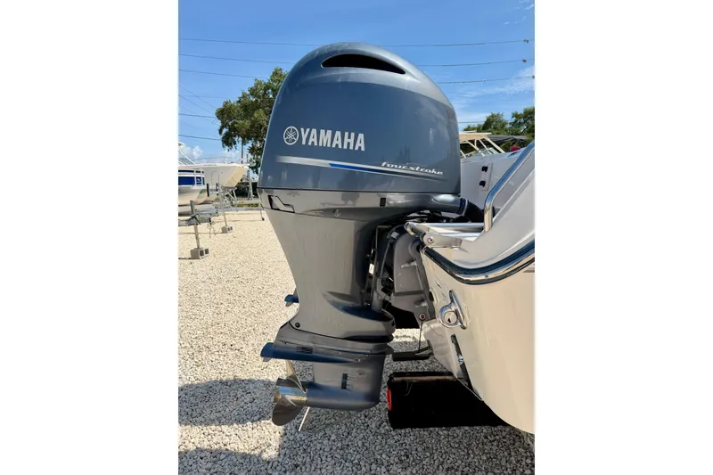Slide: The Image of Yamaha four-stroke outboard motor on 2016 Grady-White Journey 258 boat, parked on gravel. - 29