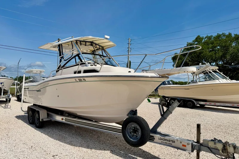 Slide: The Image of 2016 Grady-White Journey 258 boat on trailer under clear blue sky. - 3