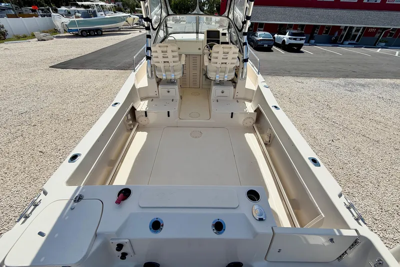 Slide: The Image of 2016 Grady-White Journey 258 boat interior, spacious deck, dual seats, and modern controls. - 8