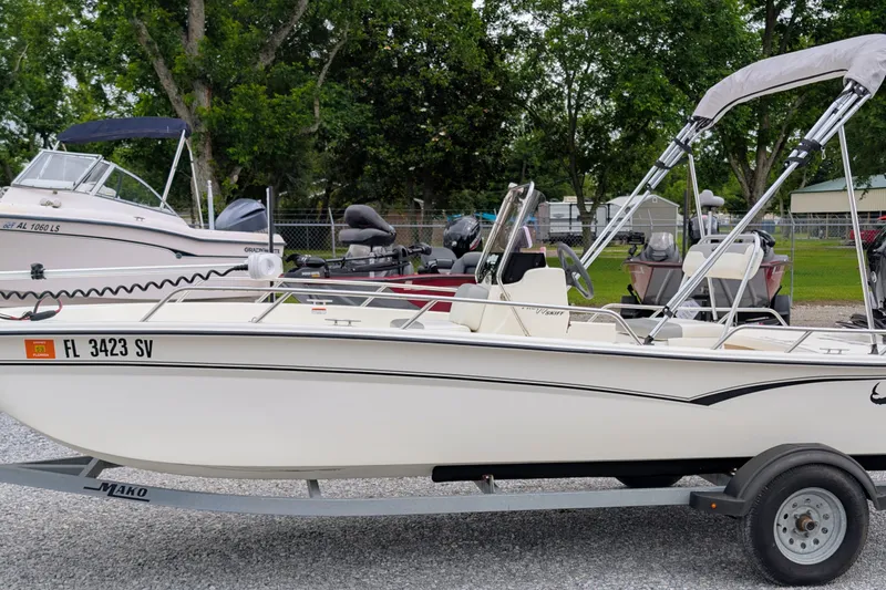 The Image of 2021 Mako Pro Skiff 17 CC boat on trailer, parked outdoors. - 0