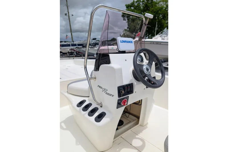Slide: The Image of 2021 Mako Pro Skiff 17 CC boat console with steering wheel and controls. - 4