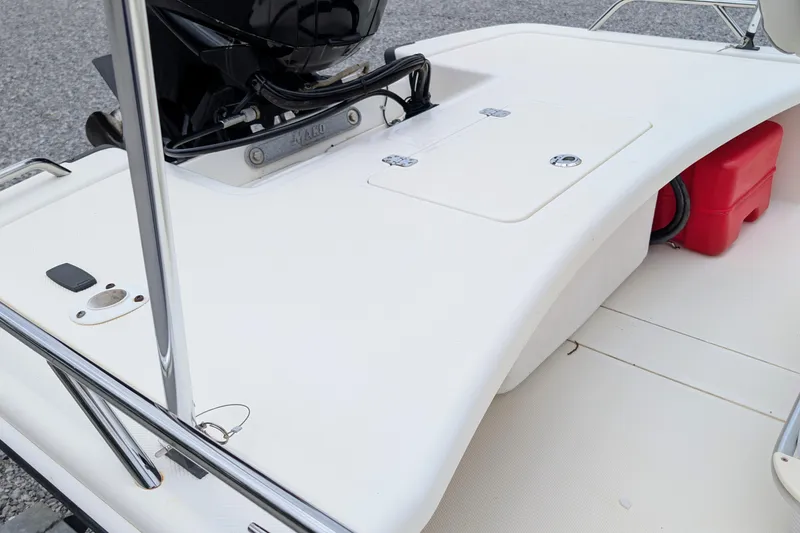 Slide: The Image of 2021 Mako Pro Skiff 17 CC boat deck with storage compartments and motor. - 6