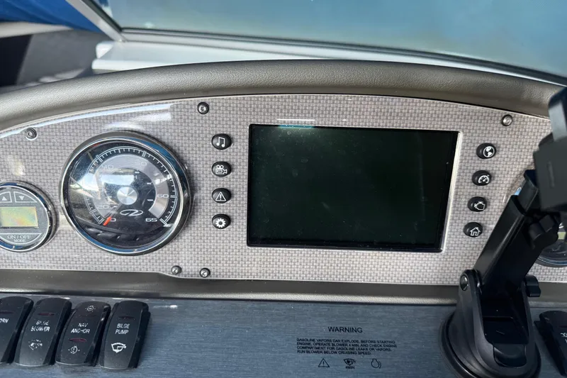Slide: The Image of Dashboard of a 2013 Regal 2100 Bowrider boat with gauges and controls. - 11