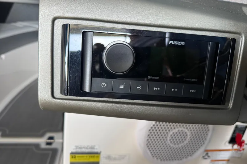 Slide: The Image of Fusion audio system on a 2013 Regal 2100 Bowrider boat dashboard. - 12