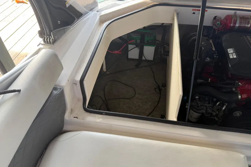 Slide: The Image of Open engine compartment of 2013 Regal 2100 Bowrider boat showing interior components. - 14