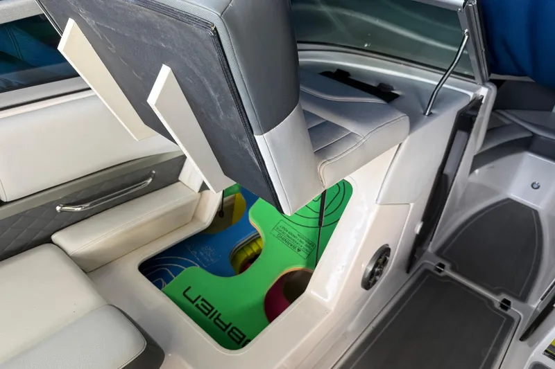 Slide: The Image of 2013 Regal 2100 Bowrider interior with storage compartment under seat. - 16