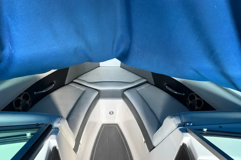 Slide: The Image of Interior of 2013 Regal 2100 Bowrider boat with blue canopy and seating. - 17